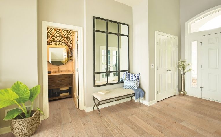 hardwood flooring in entryway with boho decor.